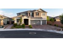 Two-story home showcasing a three-car garage and a well-maintained front yard with manicured landscaping at 2913 Monate Ct, Henderson, NV 89044