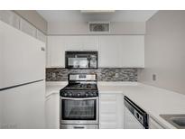 This compact kitchen is equipped with sleek, stainless steel appliances and contrasting backsplash at 3060 Tarpon Dr # 102, Las Vegas, NV 89120