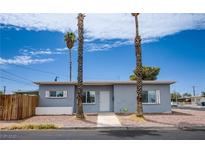 Charming single-story home featuring a manicured yard and a welcoming entrance with beautiful palm trees at 4831 Vermont Ave, Las Vegas, NV 89107