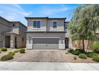 Charming two-story home with a well-maintained front yard and a two-car garage at 6106 Castle Gardens Ave, Las Vegas, NV 89130