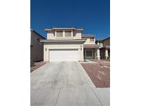 Inviting two-story home with a two-car garage and low-maintenance desert landscaping at 6425 Sierra Sands St, North Las Vegas, NV 89086