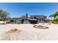 Stunning two-story home with solar panels, a fire pit, and a desert-landscaped front yard at 7135 Polaris Ave, Las Vegas, NV 89118
