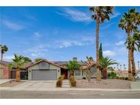 Charming single-story home featuring desert landscaping, a two-car garage, and mature palm trees at 770 Autumn Moon Dr, Las Vegas, NV 89123
