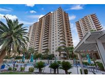 Beautiful condo building with a resort style pool, palm trees, and ample outdoor seating at 8255 Las Vegas Blvd # 1905, Las Vegas, NV 89123