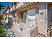 Charming townhouse featuring stucco exterior, private entry, and cozy front patio, creating a welcoming curb appeal at 901 Nevada Sky St, Las Vegas, NV 89128