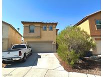 Inviting two-story home with a two-car garage and well-maintained front yard at 9148 Patrick Henry Ave, Las Vegas, NV 89149