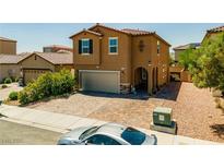 Two-story home with a two-car garage and a paved driveway at 9163 W Torino Ave, Las Vegas, NV 89148
