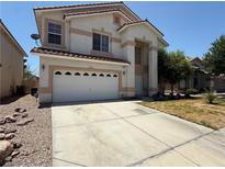 Two story home with a white garage door and concrete driveway at 925 Scarlet Haze Ave, Las Vegas, NV 89183