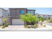 Modern two-story home with a two-car garage and landscaped front yard in a residential neighborhood at 9451 Lunar Ray St, Las Vegas, NV 89143