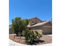 Inviting two-story home featuring a xeriscaped front yard, desert landscaping, and a two car garage at 9625 Gatesville Ave, Las Vegas, NV 89148