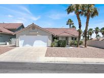 Charming single-story home with a two-car garage and a well-maintained front yard with palm trees at 118 Westin Ln, Henderson, NV 89002
