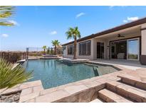 Beautiful backyard pool with spa, and lush landscaping, ideal for outdoor entertaining and relaxation at 1950 Colvin Run Dr, Henderson, NV 89052