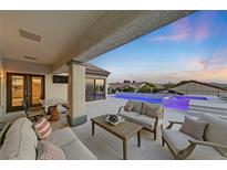 Comfortable covered patio features outdoor seating, a dining table and a beautiful view of the pool at 1999 Oliver Springs St, Henderson, NV 89052