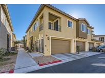 Inviting two-story home featuring a private balcony, garage, and charming architectural details at 25 Barbara Ln # 42, Las Vegas, NV 89183
