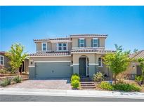 Charming two-story home featuring a well-manicured lawn, tile roof and a two-car garage at 2577 Tolmezzo St, Henderson, NV 89044
