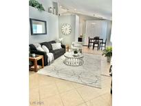 Cozy living room featuring a plush sofa, stylish rug, and ample natural light at 3329 Hidden Ridge St, Las Vegas, NV 89129