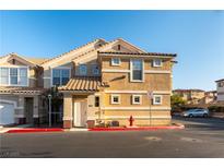 Inviting townhouse with a red tile roof, tan stucco, a red fire hydrant, and well-maintained landscaping at 5855 Valley Dr # 2145, North Las Vegas, NV 89031