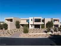 Stunning modern home with clean lines, desert landscaping, and a grand entrance creating a sophisticated curb appeal at 68 Sun Glow Ln, Las Vegas, NV 89135
