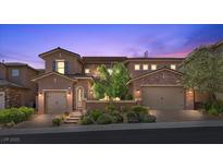 Charming two-story home featuring a well-maintained landscape, brick accents, and attached garages at 12269 Catanzaro Ave, Las Vegas, NV 89138