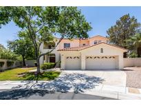 Charming two-story home with a three-car garage, tiled roof, and a well-manicured front lawn, perfect for suburban living at 1813 Francisco Peak Pl, Las Vegas, NV 89128