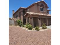 Charming two-story home featuring a well-maintained front yard and a two-car garage at 3937 Country Lights St, Las Vegas, NV 89129