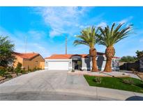 Charming single-story home boasts desert landscaping, two palm trees, and a two-car garage at 5417 Bible Cir, North Las Vegas, NV 89031