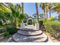 Charming two-story home with a lush, landscaped front yard and a welcoming stone walkway at 5515 N Campbell Rd, Las Vegas, NV 89149