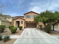Two-story home featuring a two car garage, neutral color palette and drought resistant landscaping at 5709 Nobleton Ct, North Las Vegas, NV 89081