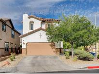 Two-story home with a neutral color scheme, well-maintained landscaping, and an attached two-car garage at 688 Monument Point St, Henderson, NV 89002