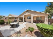Charming home featuring a covered patio with outdoor seating and a well-maintained yard at 8021 Glacier Falls St, North Las Vegas, NV 89085