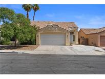 Charming single-story home with a two-car garage, desert landscaping, and a tile roof at 920 Serpentina Ave, Las Vegas, NV 89123