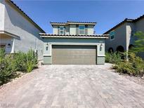 Two-story home features a wide driveway, two-car garage, and simple landscaping for great curb appeal at 9348 Wildcat Peak St, Las Vegas, NV 89178