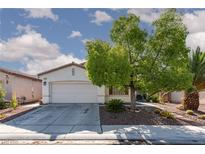 Charming single-story home featuring a well-manicured yard and inviting curb appeal with mature trees at , North Las Vegas, NV 89031