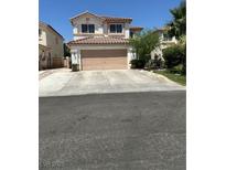 Two-story home with a two-car garage and tile roof at 10265 Moth Orchid Ct, Las Vegas, NV 89183