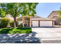 Charming home with a well-maintained lawn and a three-car garage at 1779 Antelope Valley Ave, Henderson, NV 89012