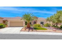 Charming single-story home with desert landscaping, a palm tree, and a two-car garage at 2205 Sandstone Cliffs Dr, Henderson, NV 89044