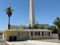 Charming single-story home with palm tree and view of The Strat tower in the background at 2400 Santa Paula Dr, Las Vegas, NV 89104