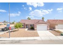Charming single-story home with a well-maintained front yard and a two-car garage at 2403 Sexton Ave, North Las Vegas, NV 89031