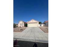 Inviting single-story home featuring a two-car garage and low maintenance desert landscaping in the front yard at 4724 Victoria Beach Way, Las Vegas, NV 89130