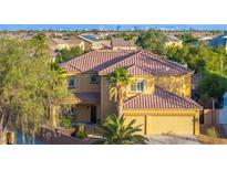 Beautiful two-story home featuring a red tile roof, attached two-car garage, and lush landscaping at 5805 Cabo San Lucas Ave, Las Vegas, NV 89131