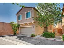 Inviting two-story home with a two-car garage, desert landscaping, and a charming facade at 635 Taliput Palm Pl, Henderson, NV 89011