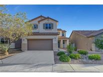 Charming two-story home with a well-manicured front yard and attached two-car garage, perfect for suburban living at 1069 Aspen Cliff Dr, Henderson, NV 89011