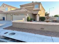 Inviting two-story home featuring a well-manicured front yard and neutral color palette at 1333 Pacific Terrace Dr, Las Vegas, NV 89128