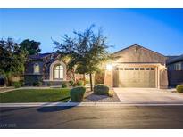 Charming single-story home with a well-manicured lawn and a two-car garage at twilight at 2172 De Rouge Ave, Henderson, NV 89044