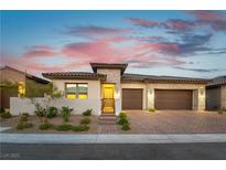 Charming single-story home with a two-car garage and manicured landscaping at twilight at 218 Vista Balla Ave, Las Vegas, NV 89138