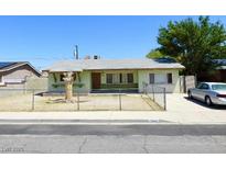 Modest single story home with xeriscaped yard and chain link fence at 2813 Willoughby Ave, Las Vegas, NV 89101