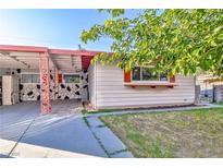 Charming single-story home showcasing a quaint covered patio, tidy lawn, and unique stone accents at 304 Perkins Cir, Las Vegas, NV 89106
