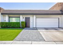 Charming home features a two-car garage, manicured lawn, and lovely front entrance at 3380 Kensbrook St, Las Vegas, NV 89121