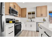 Bright kitchen with stainless steel appliances, white countertops, and modern cabinetry at 5030 E Hacienda Ave, Las Vegas, NV 89122