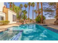 Inviting backyard pool with clear water and palm tree landscaping at 5228 Painted Lakes Way, Las Vegas, NV 89149